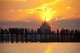 Burma / Myanmar: People gather to watch the sunset on the U Bein Bridge, the longest teakwood bridge in the world, Taungthaman Lake, near Amarapura, Mandalay